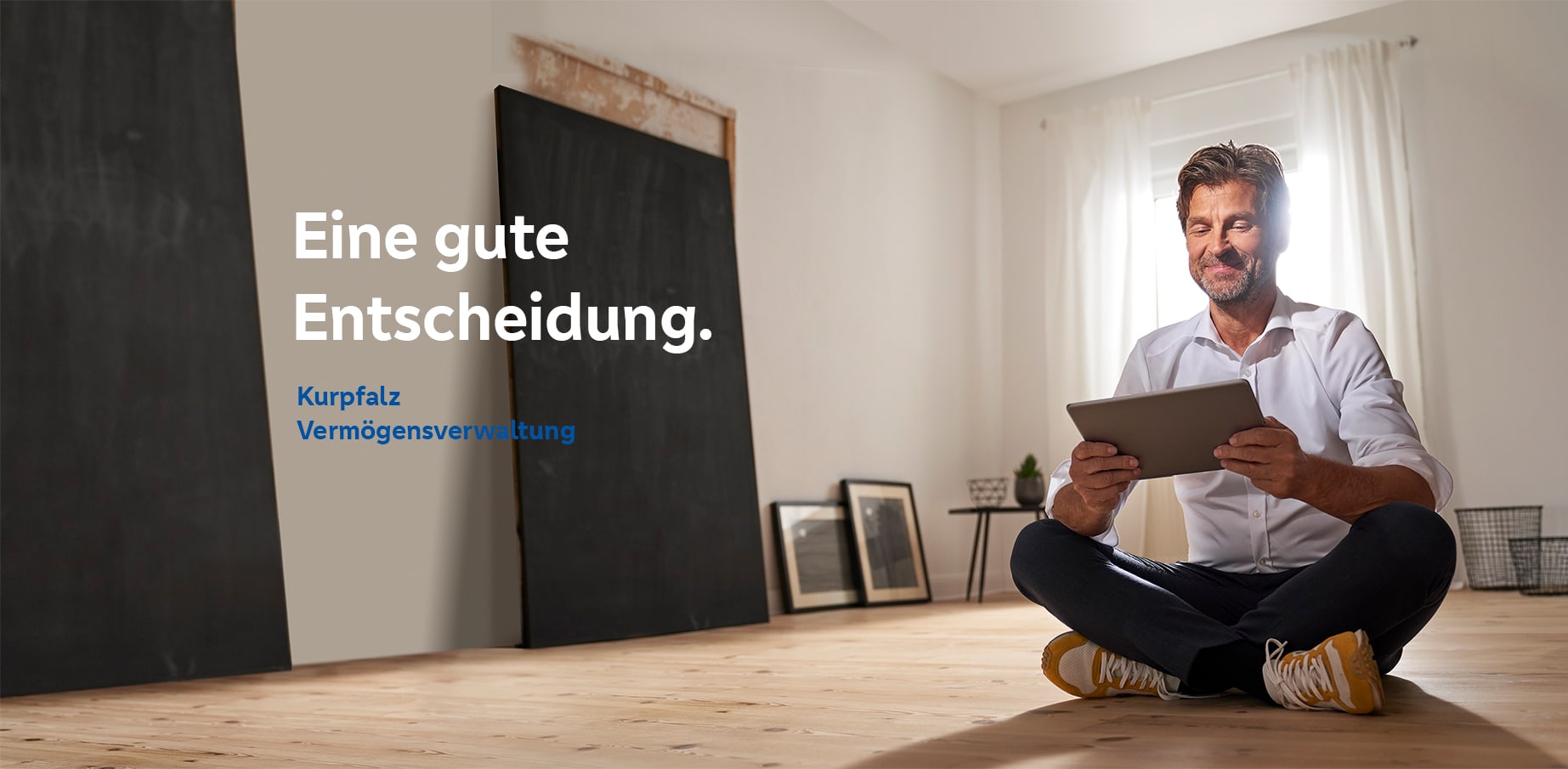 Ein Mann mit einem Tablet freut sich über das Kurpfalz Vermögensverwaltung Angeobot